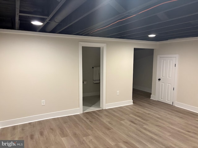 finished basement featuring wood finished floors and baseboards