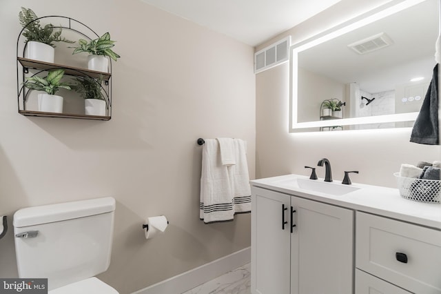 bathroom with marble finish floor, visible vents, vanity, and toilet