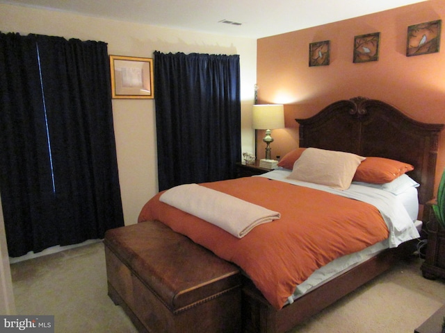 bedroom featuring carpet floors and visible vents