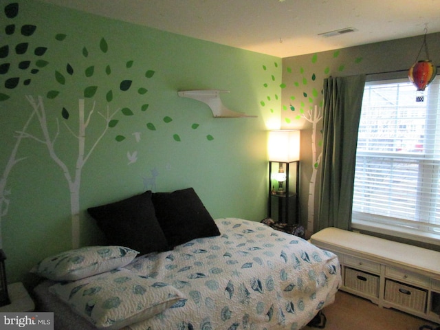 bedroom featuring wallpapered walls, multiple windows, and visible vents