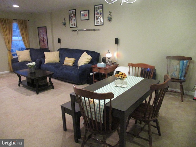 dining room featuring carpet floors and baseboards