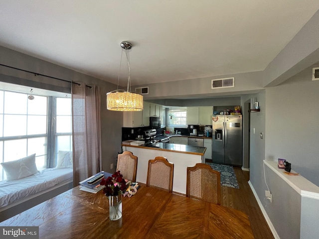 dining space featuring baseboards, visible vents, and dark wood-style flooring