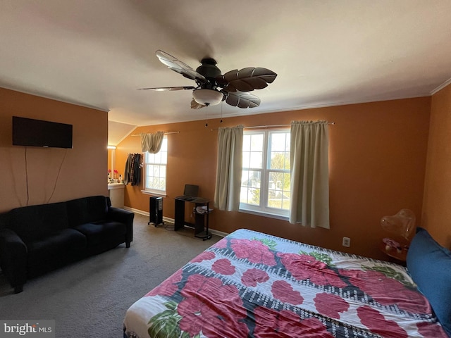 carpeted bedroom with baseboards and a ceiling fan