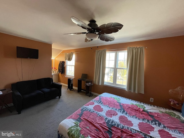 carpeted bedroom with a ceiling fan and baseboards