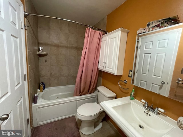 bathroom featuring shower / bath combo, a sink, and toilet