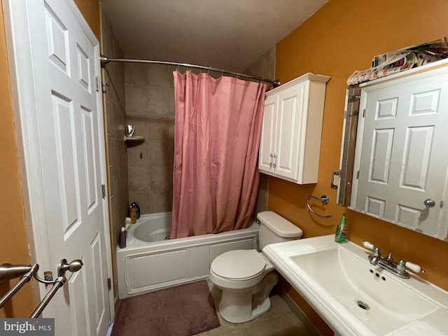 bathroom featuring shower / tub combo, a sink, and toilet