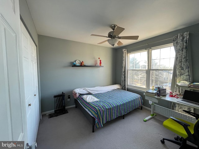 bedroom with carpet floors, a closet, a ceiling fan, and baseboards