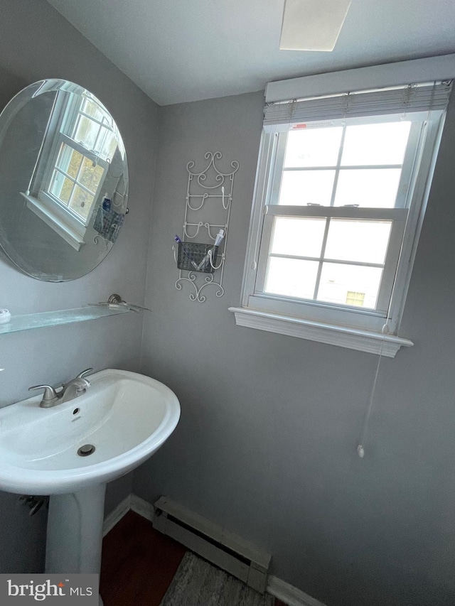 bathroom with a baseboard radiator and baseboards