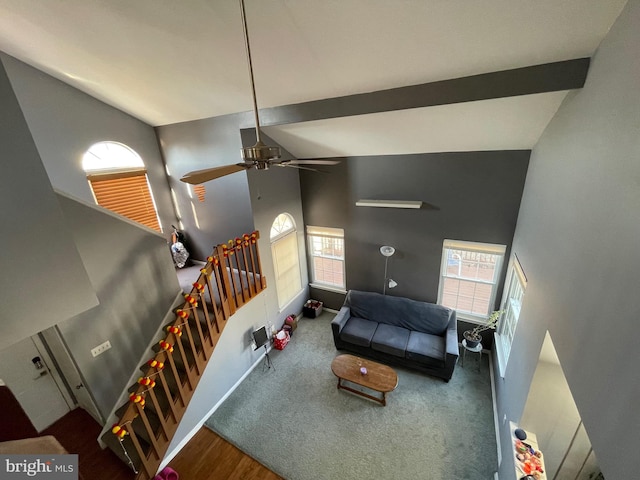 living room featuring a ceiling fan, beam ceiling, high vaulted ceiling, and baseboards