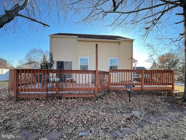 back of house with a deck