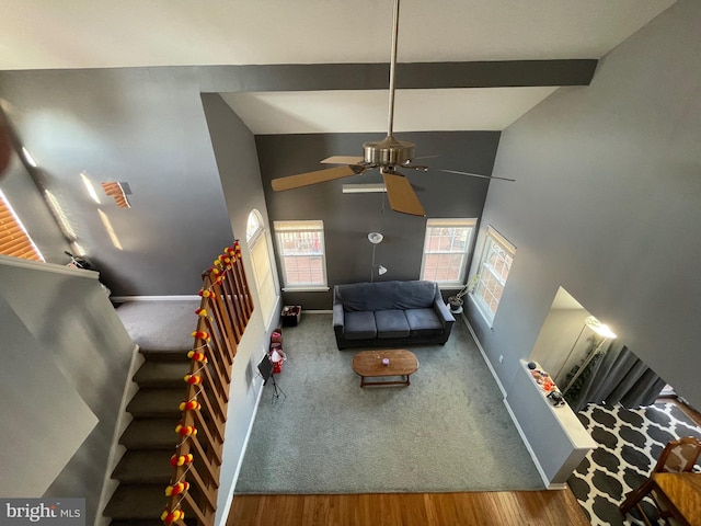 recreation room featuring high vaulted ceiling, a ceiling fan, baseboards, and beamed ceiling