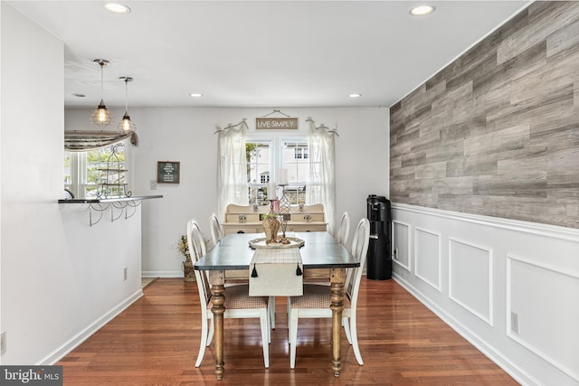 dining space with wainscoting, recessed lighting, and wood finished floors