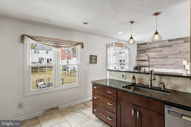 kitchen featuring visible vents, a sink, plenty of natural light, decorative backsplash, and dishwasher