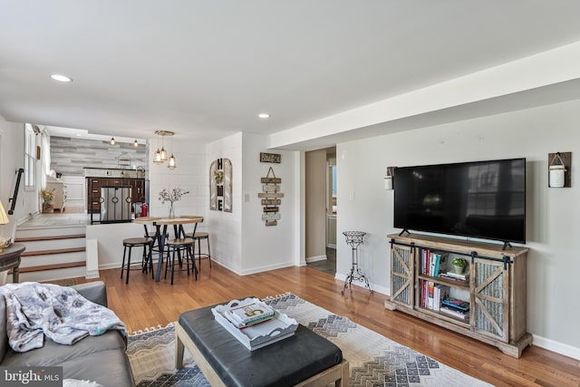 living room with stairway, recessed lighting, and wood finished floors