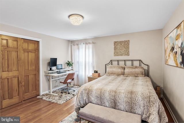 bedroom featuring baseboards and wood finished floors