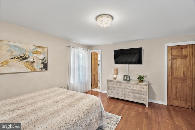 bedroom featuring baseboards and hardwood / wood-style floors