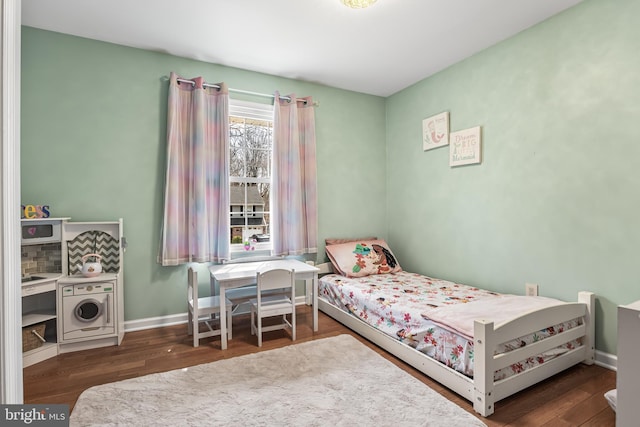 bedroom with baseboards and wood finished floors