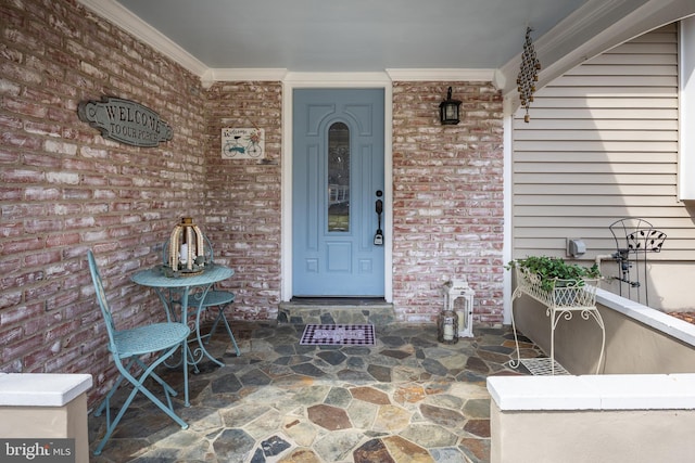 doorway to property with brick siding