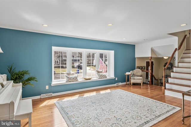 sitting room featuring visible vents, baseboards, stairs, and hardwood / wood-style flooring