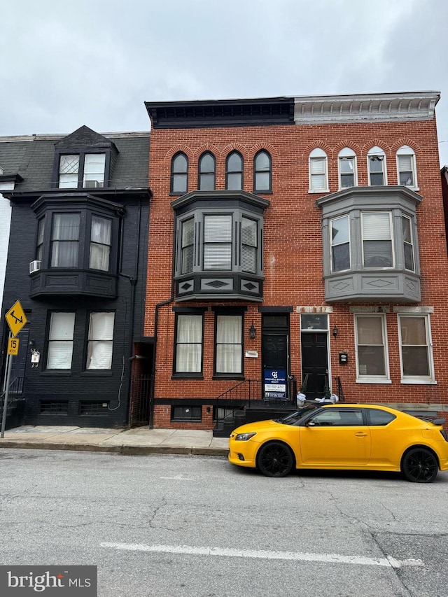 townhome / multi-family property featuring brick siding