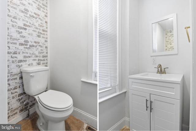 bathroom with toilet, visible vents, baseboards, vanity, and tile patterned floors