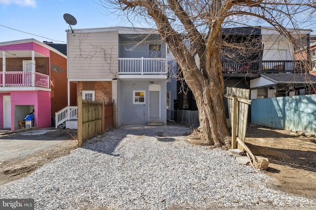 back of property with fence and brick siding