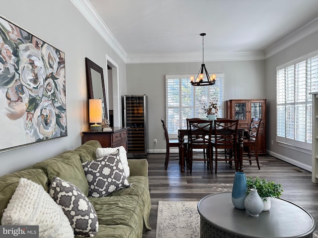 living area with a notable chandelier, a healthy amount of sunlight, and ornamental molding