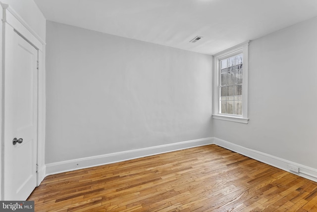 unfurnished room with visible vents, baseboards, and light wood finished floors