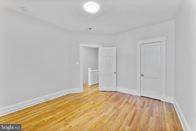 unfurnished bedroom featuring light wood-type flooring and baseboards