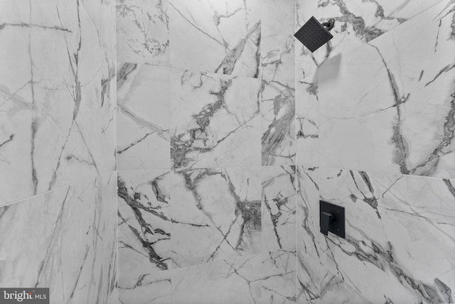 room details featuring a marble finish shower