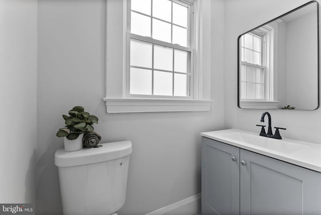 bathroom featuring toilet and vanity