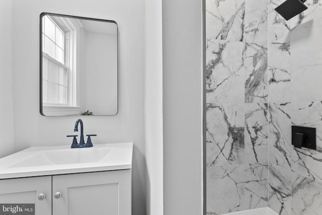 bathroom with vanity and a shower