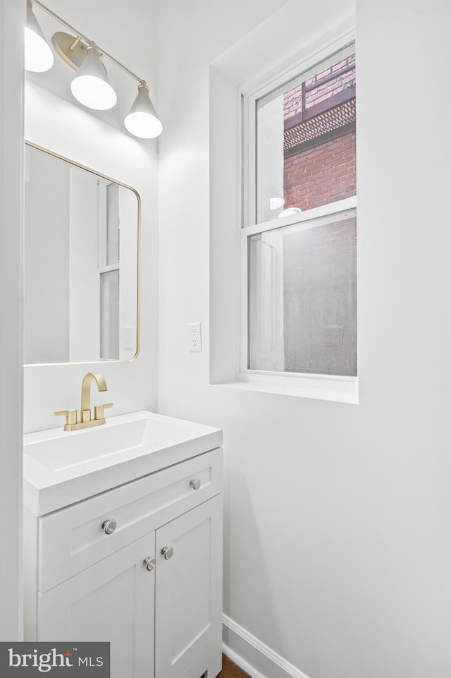 bathroom with vanity and baseboards