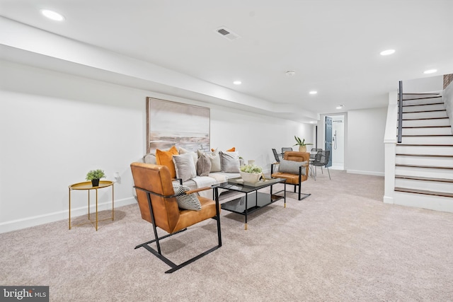 carpeted living area with baseboards, stairway, visible vents, and recessed lighting