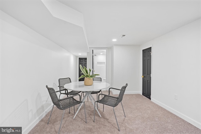 carpeted dining room featuring recessed lighting, visible vents, and baseboards