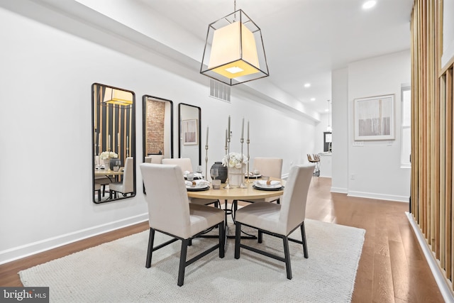 dining space with visible vents, baseboards, wood finished floors, and recessed lighting