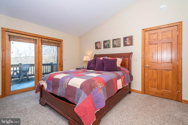 carpeted bedroom with access to outside, lofted ceiling, and baseboards