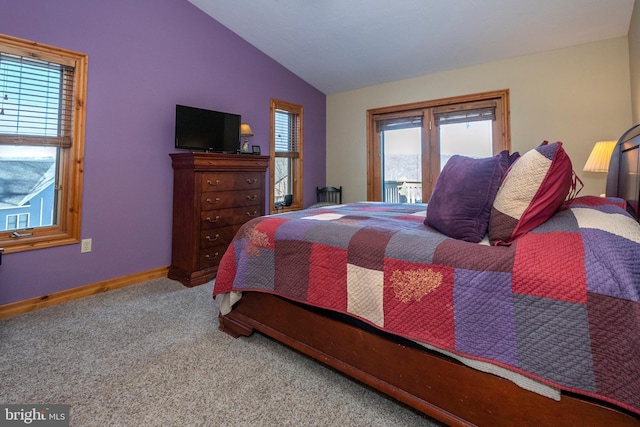 bedroom featuring lofted ceiling, baseboards, and carpet