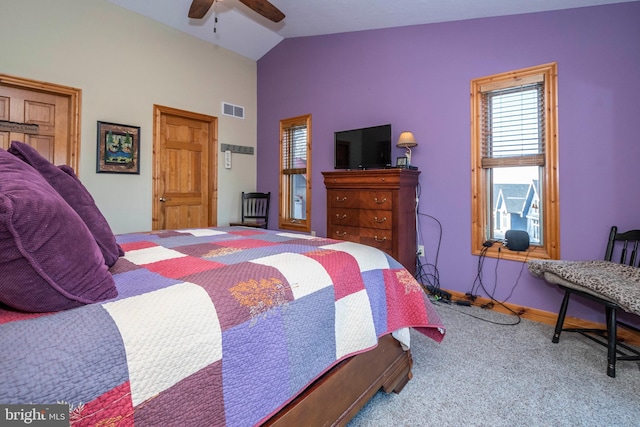 carpeted bedroom featuring lofted ceiling, baseboards, visible vents, and a ceiling fan