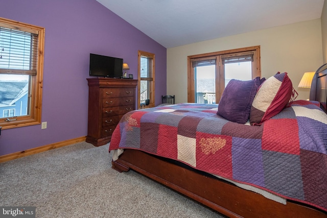 bedroom with carpet floors, baseboards, and vaulted ceiling