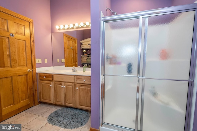 full bathroom featuring tile patterned flooring, vanity, and a shower stall