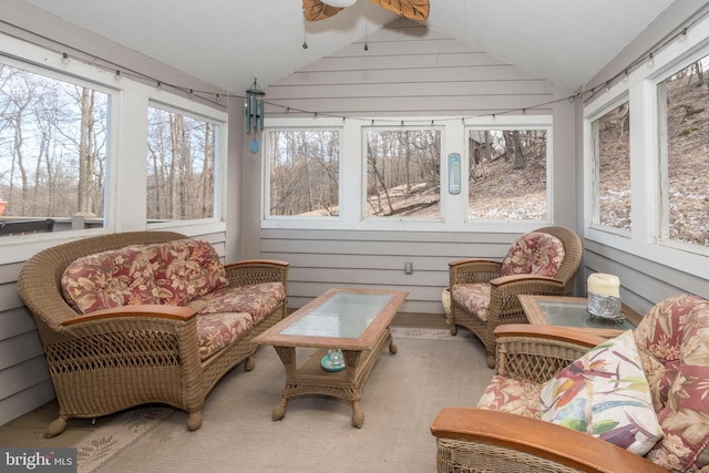 sunroom / solarium with a ceiling fan and lofted ceiling