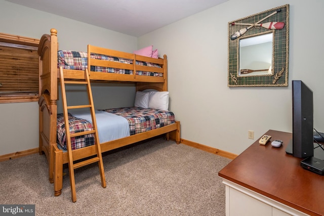 carpeted bedroom featuring baseboards