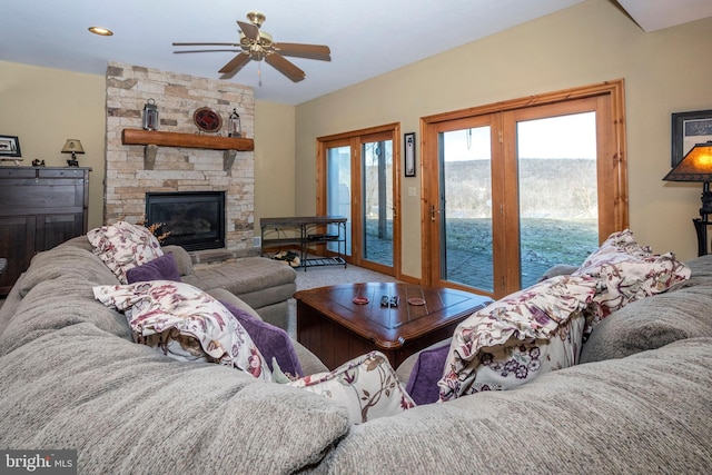 living room with a fireplace and a ceiling fan