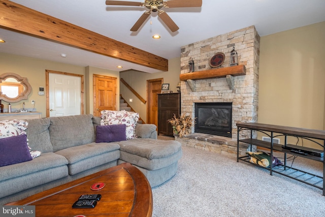 carpeted living area featuring a stone fireplace, recessed lighting, a ceiling fan, stairs, and beam ceiling