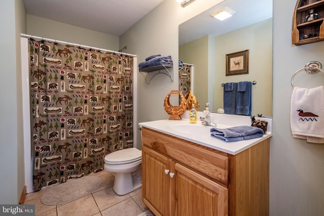 bathroom with tile patterned flooring, curtained shower, vanity, and toilet