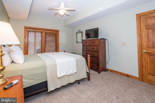 bedroom featuring ceiling fan, baseboards, and light colored carpet