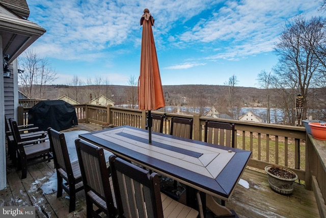 deck with outdoor dining area and area for grilling