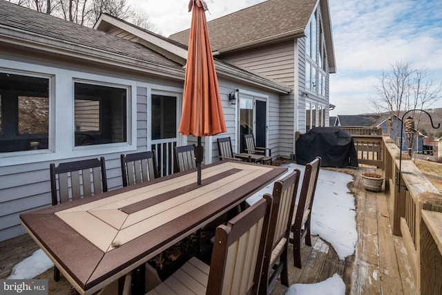 wooden terrace featuring entry steps, outdoor dining area, and a grill