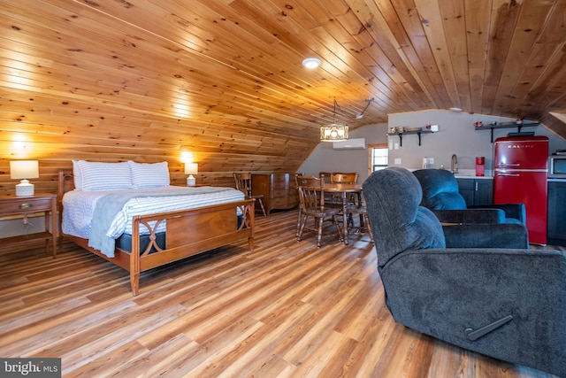 bedroom featuring lofted ceiling, wooden ceiling, light wood-style flooring, refrigerator, and a sink